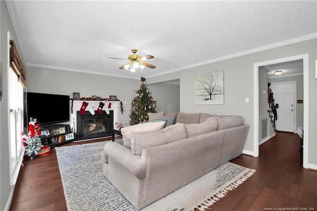 living room with dark wood-type flooring, ornamental molding, and ceiling fan