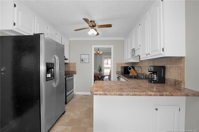 kitchen featuring ceiling fan with notable chandelier, white cabinets, appliances with stainless steel finishes, tasteful backsplash, and sink