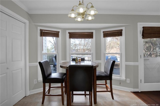 dining space with ornamental molding and a notable chandelier