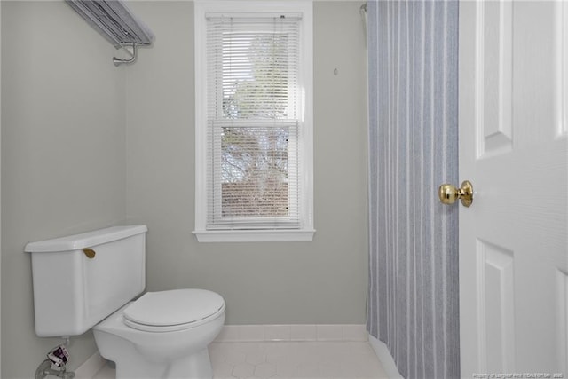 bathroom with tile patterned floors and toilet