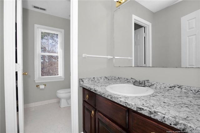 bathroom with tile patterned floors, vanity, and toilet