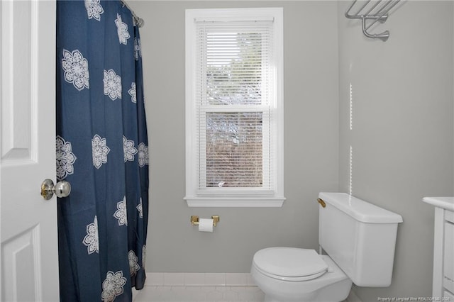 bathroom with toilet and tile patterned flooring