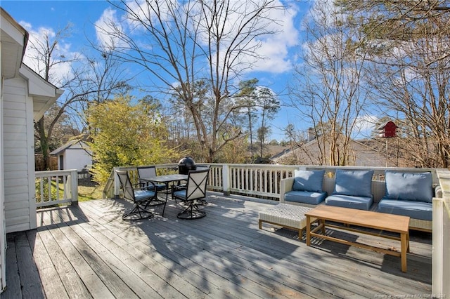 deck featuring a shed and outdoor lounge area