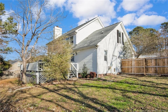 rear view of house featuring a yard