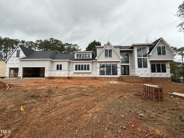 rear view of house featuring a garage