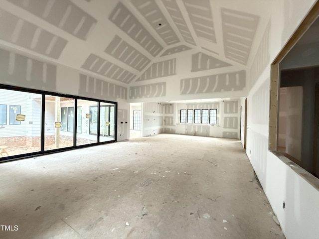 unfurnished room featuring high vaulted ceiling