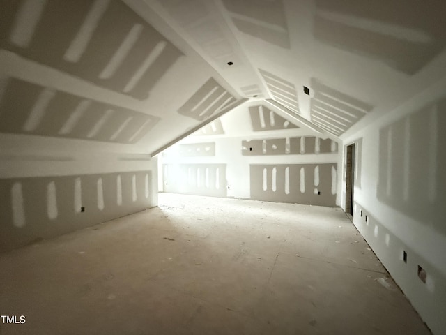 additional living space featuring lofted ceiling