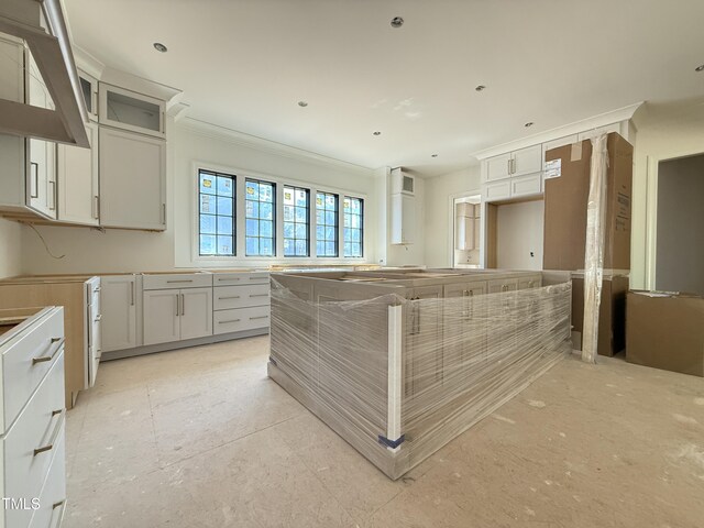 kitchen with white cabinets, ornamental molding, and glass insert cabinets