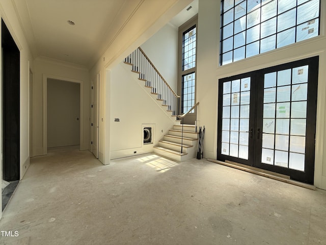 interior space with stairs, crown molding, and french doors