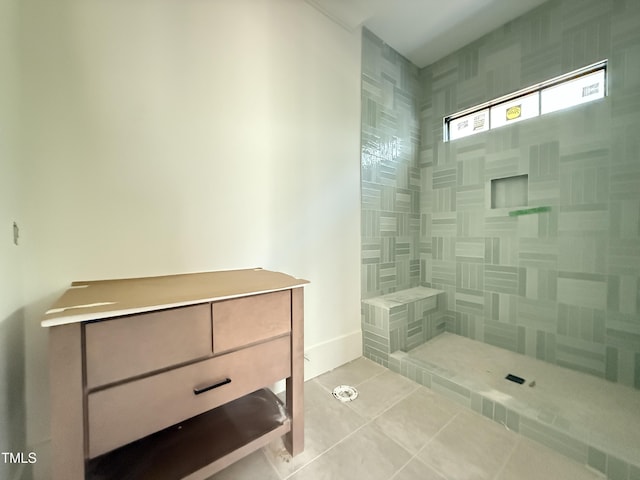 full bath featuring tile patterned flooring and a tile shower