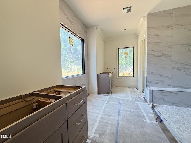 hallway featuring crown molding and a wealth of natural light