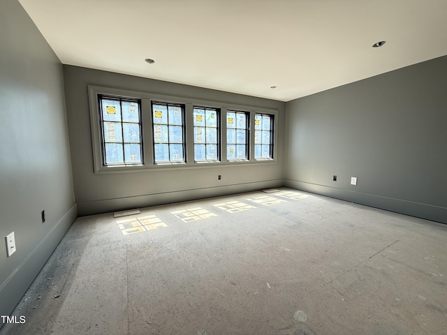 unfurnished room featuring baseboards