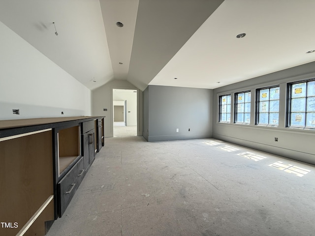 unfurnished living room with lofted ceiling