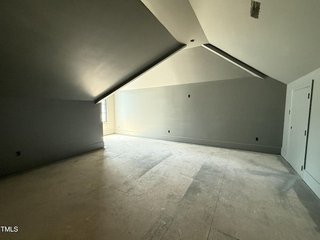 additional living space featuring vaulted ceiling
