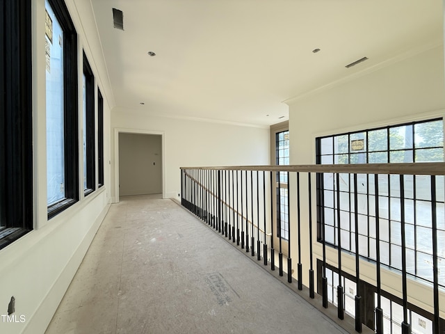 corridor with baseboards and ornamental molding