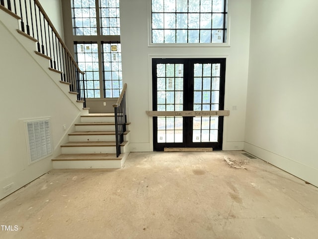 7013 Buckhead Dr, Raleigh, NC 27615 - entryway with french doors, stairway, healthy amount of natural light, and a high ceiling