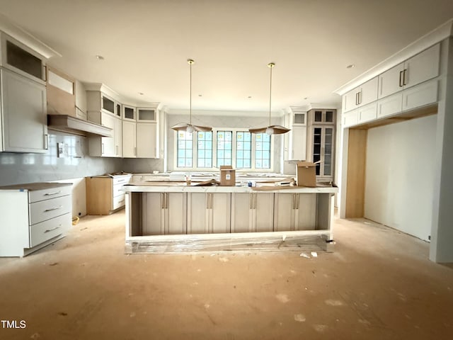 7013 Buckhead Dr, Raleigh, NC 27615 - kitchen with a kitchen island, tasteful backsplash, glass insert cabinets, pendant lighting, and white cabinetry