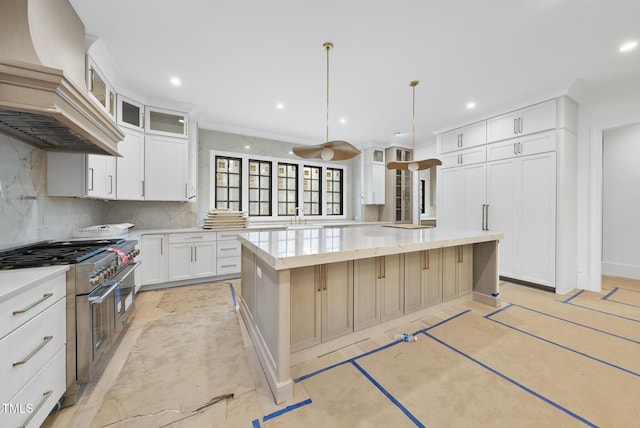 7013 Buckhead Dr, Raleigh, NC 27615 - kitchen with premium range hood, double oven range, a kitchen island, backsplash, and recessed lighting