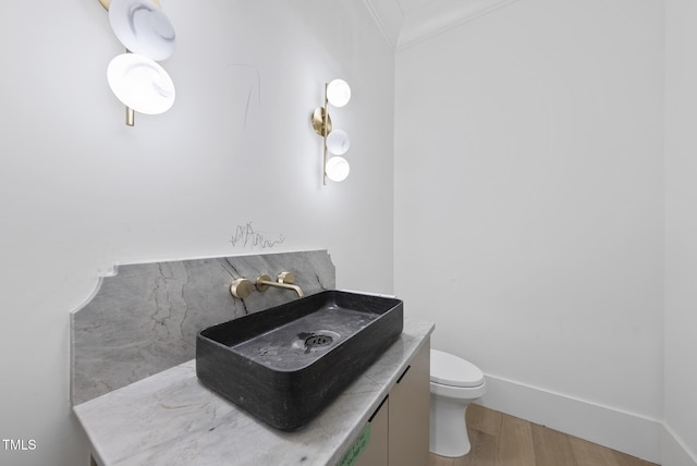 7013 Buckhead Dr, Raleigh, NC 27615 - half bathroom featuring crown molding, wood finished floors, and vanity