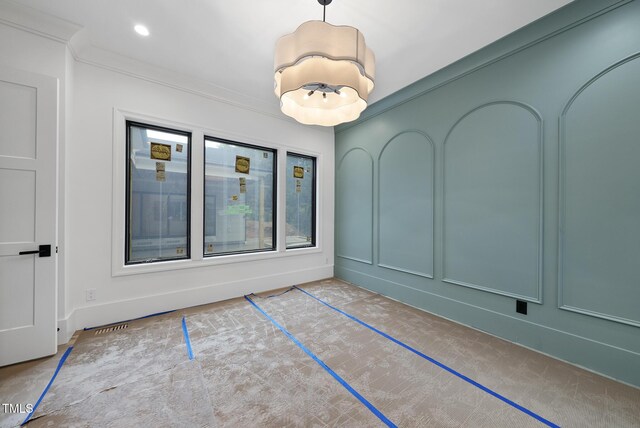 7013 Buckhead Dr, Raleigh, NC 27615 - spare room featuring ornamental molding and a chandelier