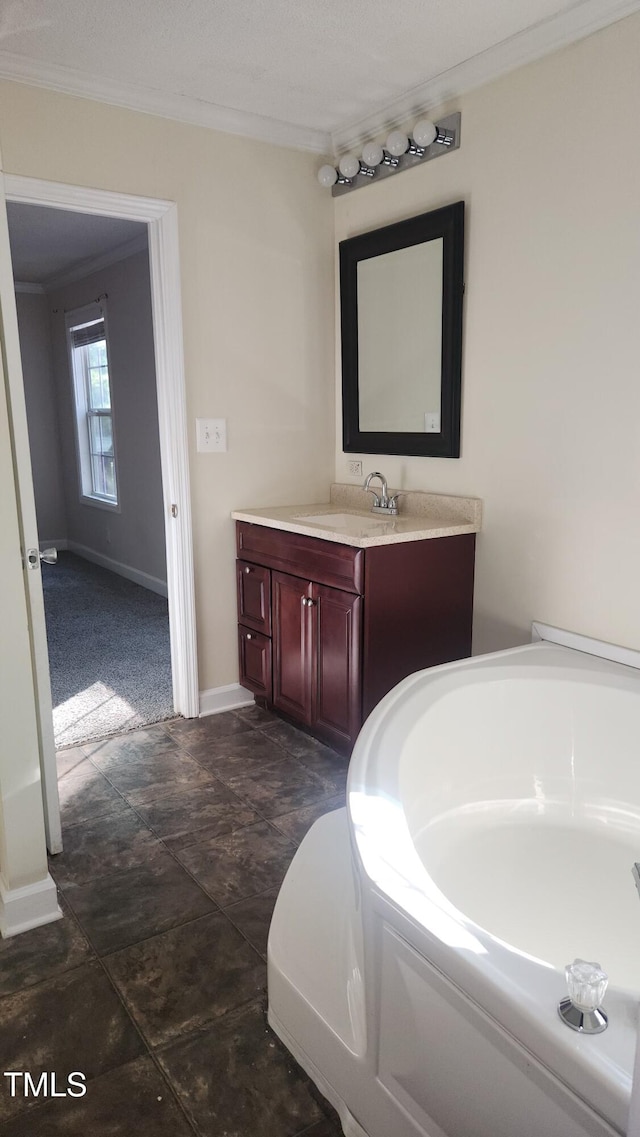 bathroom featuring crown molding, vanity, and a washtub