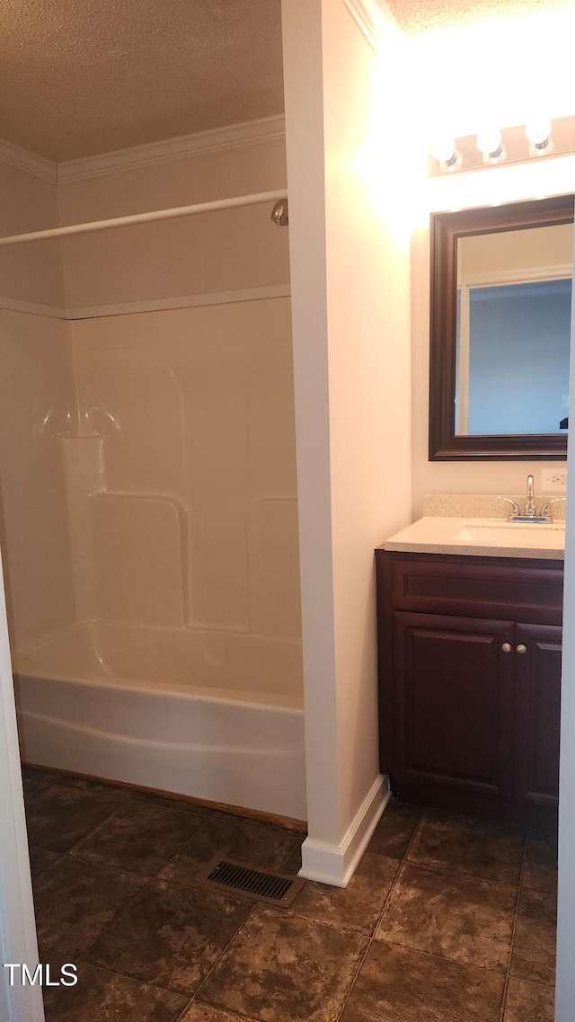 bathroom with vanity, crown molding, and bathtub / shower combination