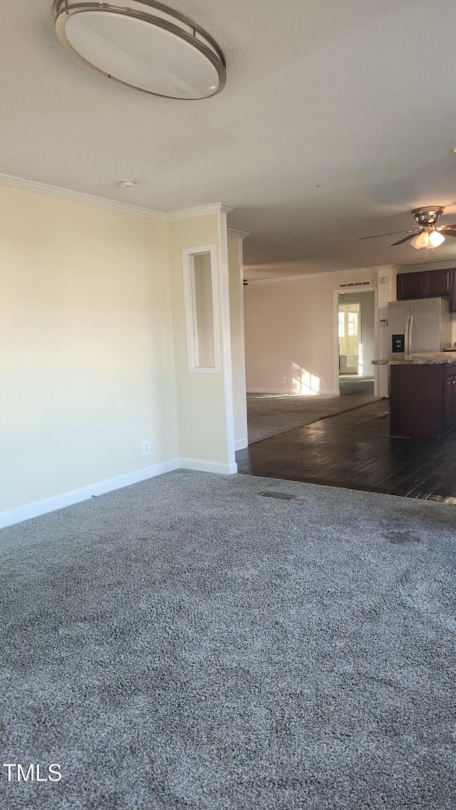 unfurnished living room with crown molding and ceiling fan