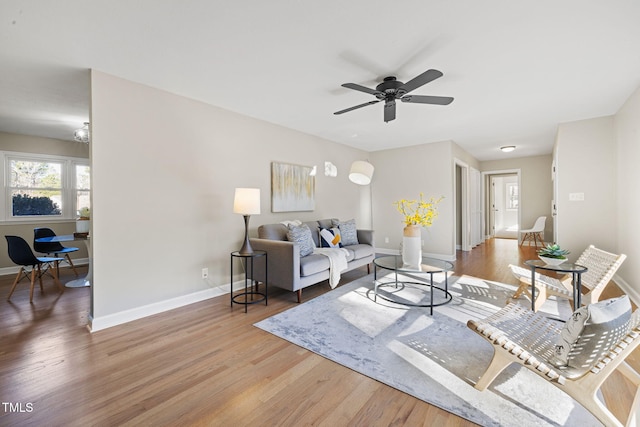 living room featuring hardwood / wood-style flooring and ceiling fan