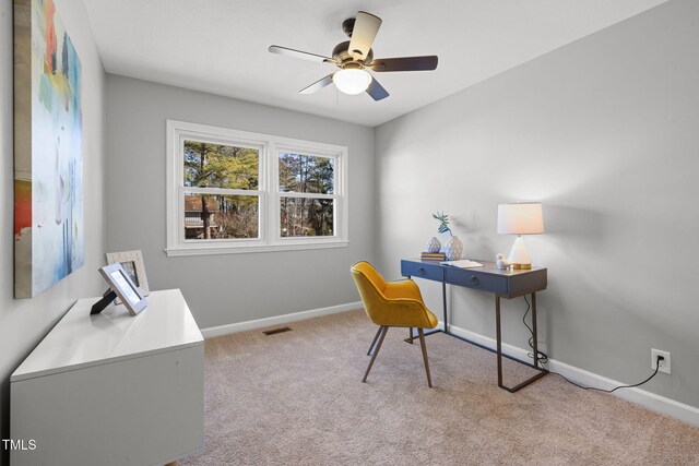 carpeted home office with ceiling fan