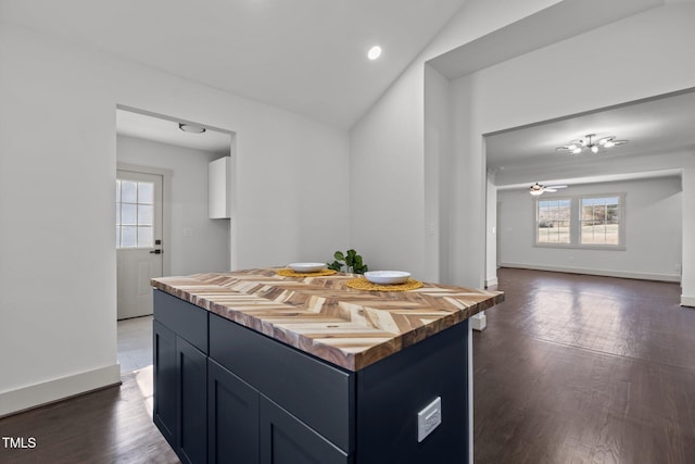 kitchen featuring ceiling fan, a kitchen island, dark hardwood / wood-style flooring, and lofted ceiling