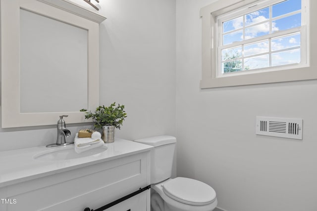 bathroom with toilet and vanity