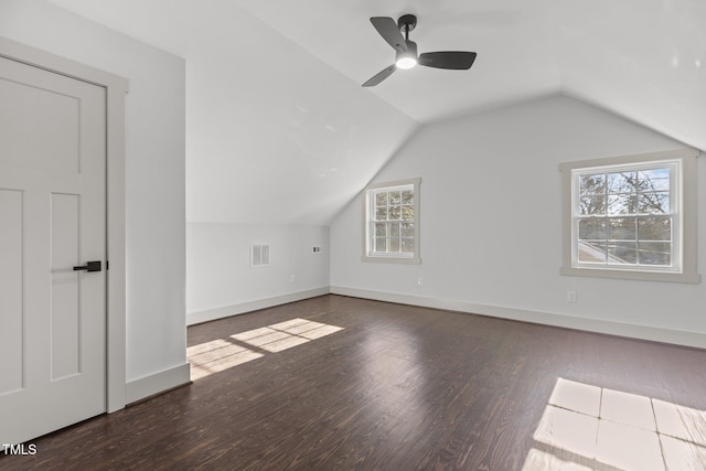 bonus room with vaulted ceiling, ceiling fan, and dark wood-type flooring