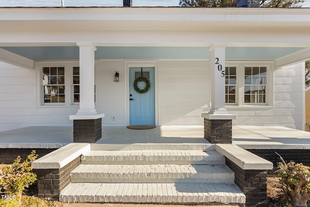 view of exterior entry with a porch