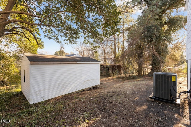 view of yard with central AC and a storage unit