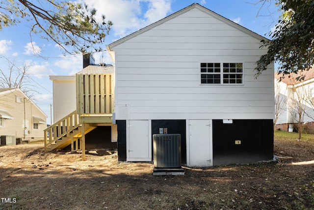 back of house with central air condition unit