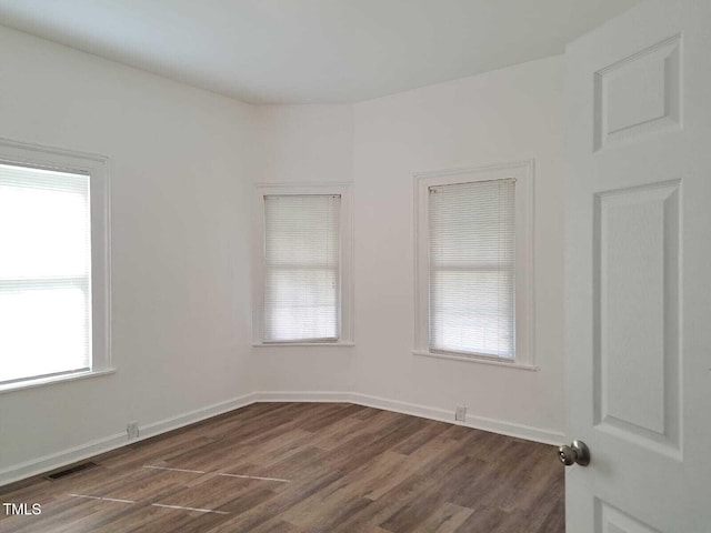 unfurnished room featuring dark hardwood / wood-style flooring