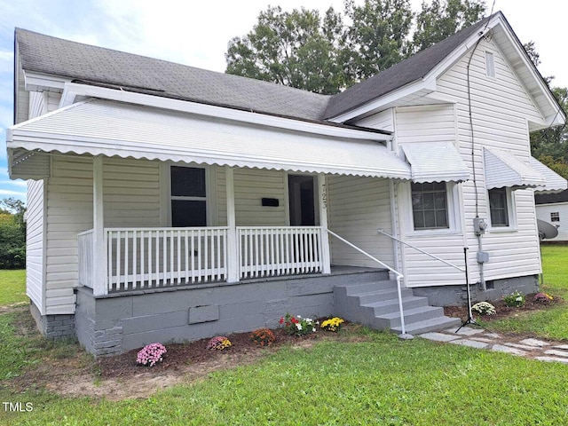 view of front of property with a front yard and a porch