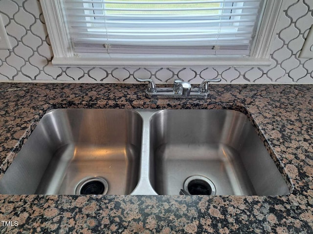 room details featuring sink and dark stone counters