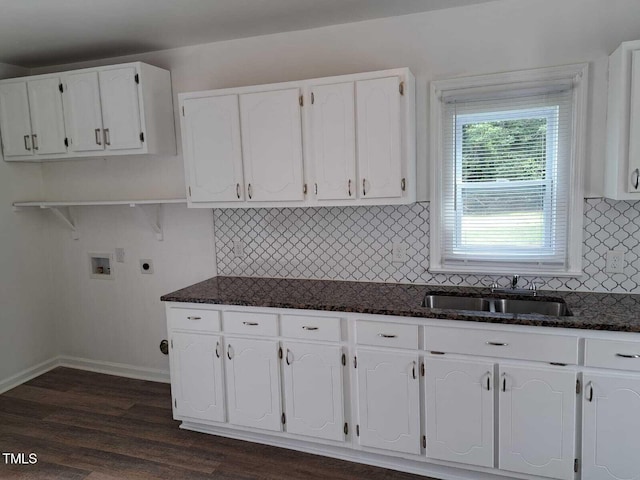 kitchen with sink, white cabinets, and dark stone countertops