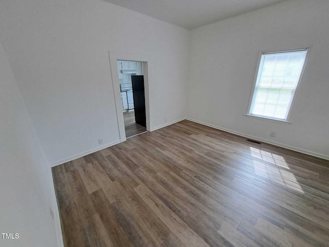 spare room with hardwood / wood-style floors