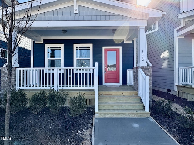 doorway to property featuring covered porch