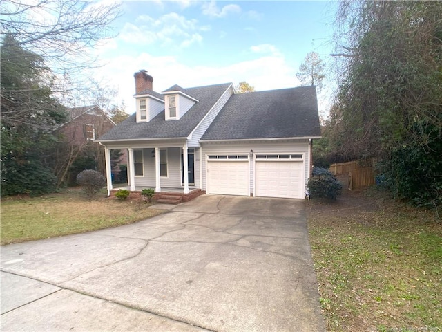 cape cod-style house featuring a garage, a front lawn, and covered porch