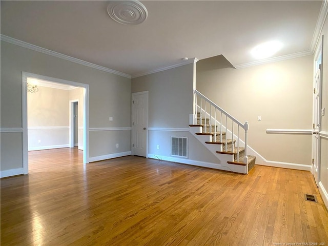 unfurnished living room with wood-type flooring and crown molding