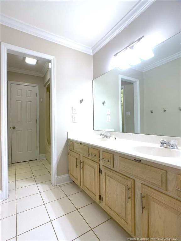 bathroom featuring tile patterned flooring, crown molding, and vanity