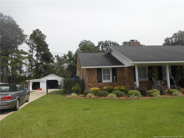 view of side of property featuring a garage and a lawn