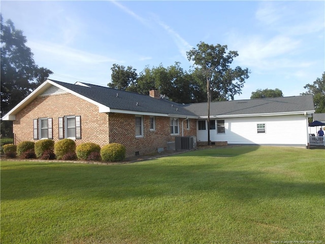 view of property exterior with a yard and central air condition unit