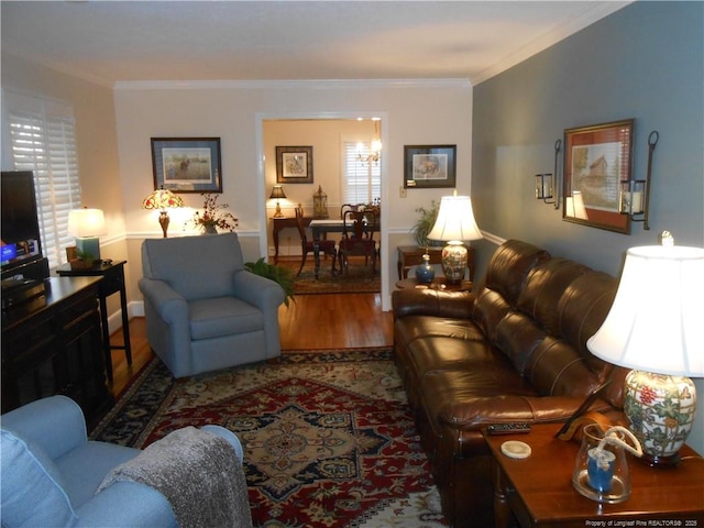 living room with hardwood / wood-style floors and crown molding