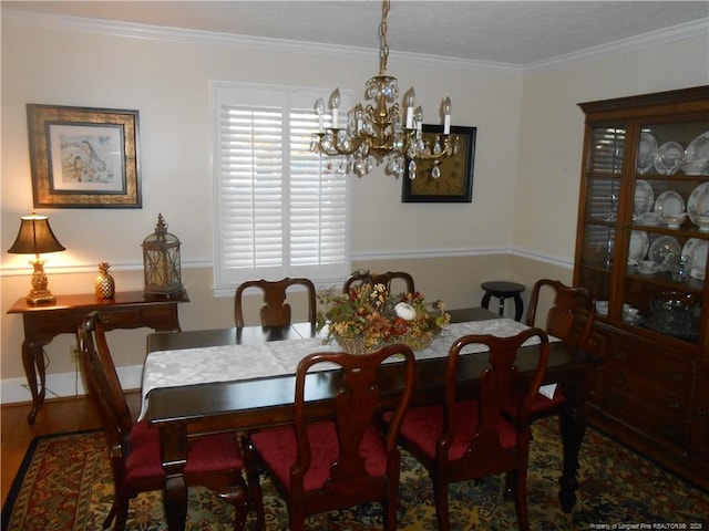 dining room with ornamental molding, dark wood-type flooring, and a chandelier