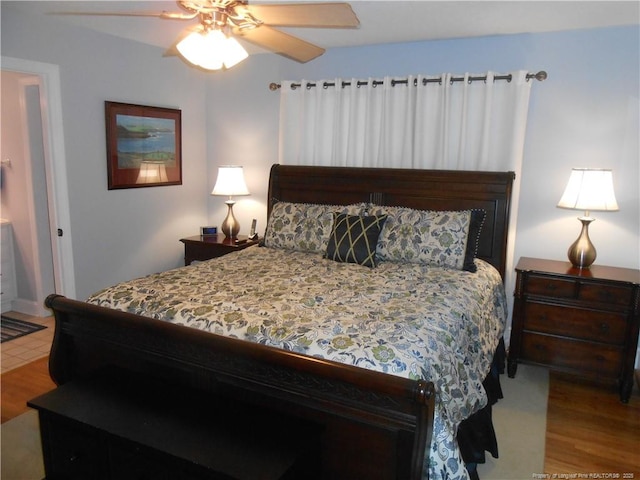 bedroom featuring hardwood / wood-style flooring and ceiling fan