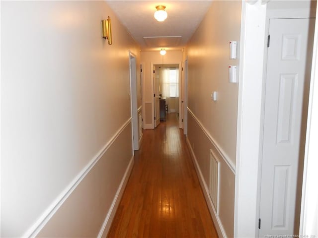 hallway with wood-type flooring